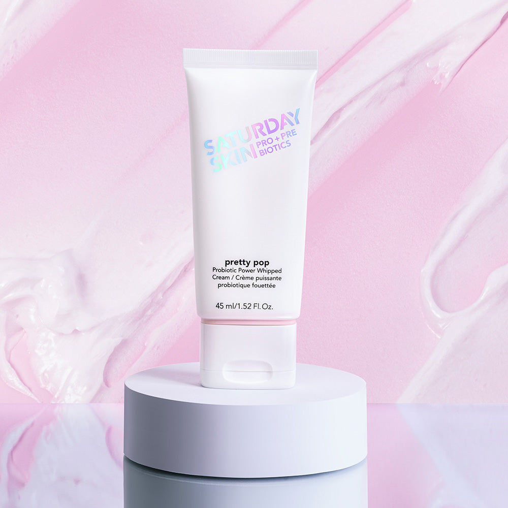 Skincare tube labeled 'Saturday Skin' on a pink background