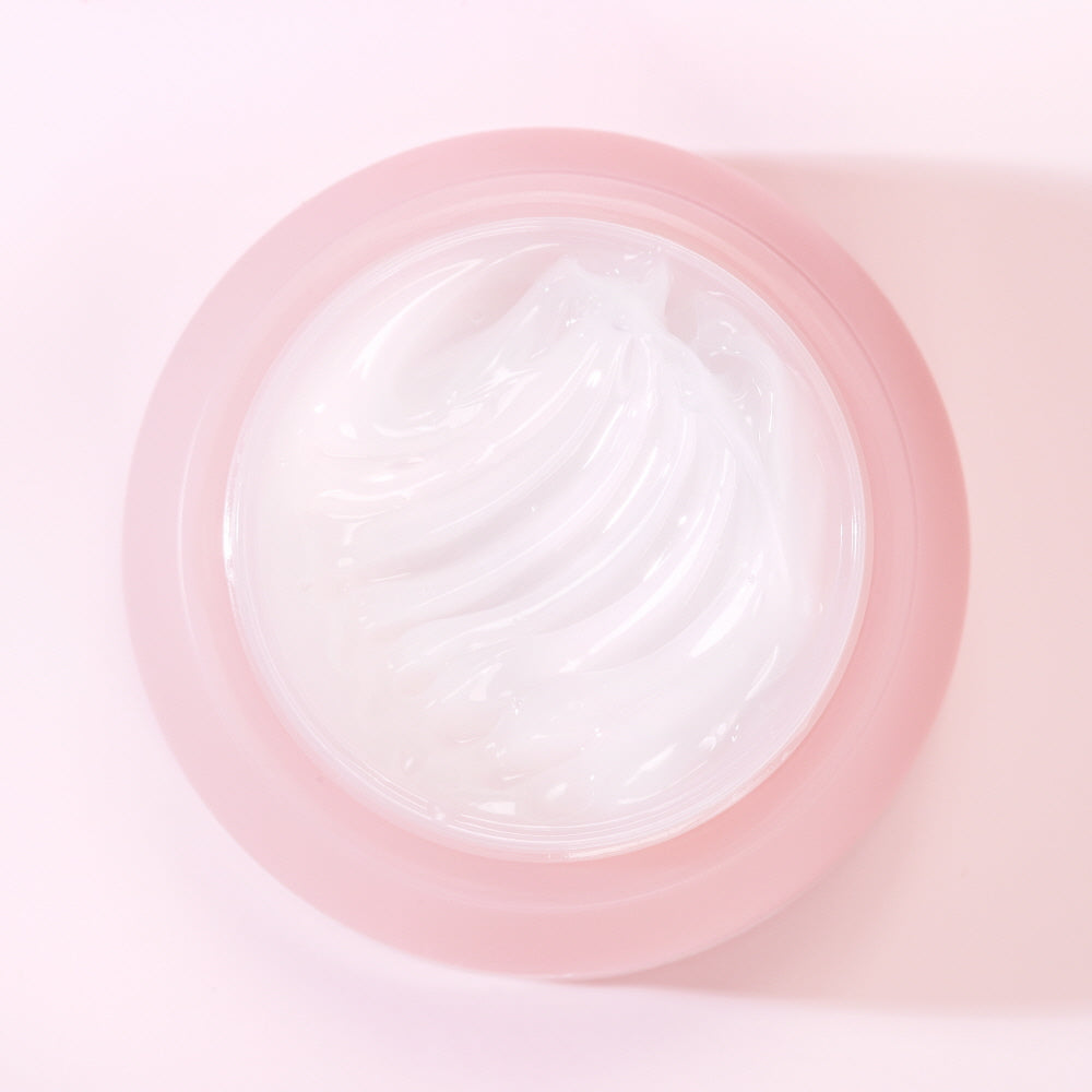 Close-up of a pink contact lens case with a clear lens inside on a light pink background