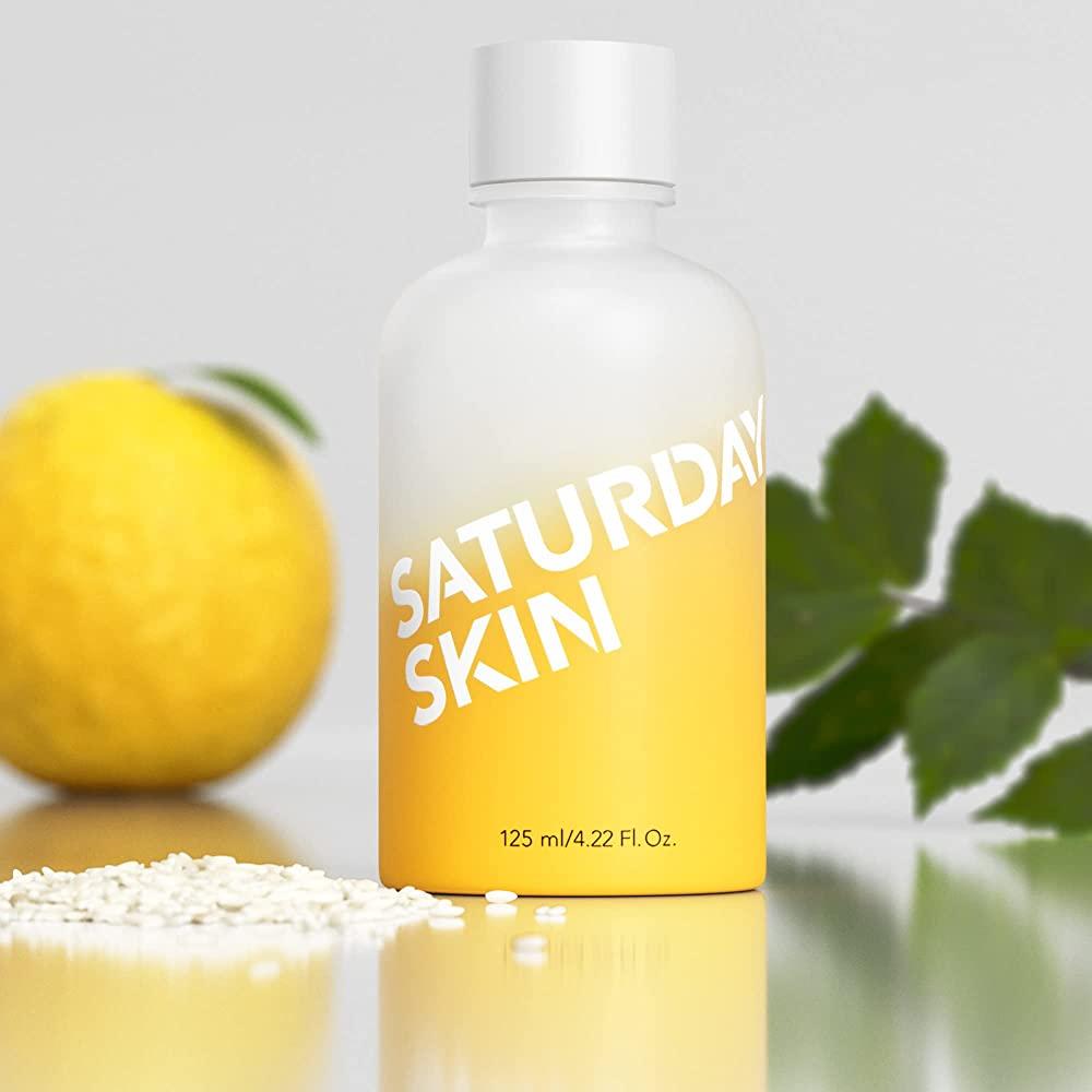 Saturday Skin skincare product bottle with a lemon and green leaves in the background